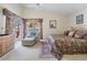 Bright main bedroom featuring a patio door and large window letting in lots of natural light at 9008 Quail Creek Dr, Tampa, FL 33647