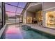 Tranquil screened-in pool and covered lanai provides the perfect retreat to relax in luxury at 9008 Quail Creek Dr, Tampa, FL 33647