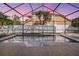 Relaxing enclosed pool with a view of the backyard's fencing and landscaping at 9008 Quail Creek Dr, Tampa, FL 33647