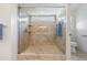Modern tiled shower with glass enclosure, window, and built-in shelves in the main bathroom at 9008 Quail Creek Dr, Tampa, FL 33647