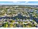Aerial view of waterfront community with canals, lush landscaping, and homes with docks along the water at 9107 Bay Ne St, St Petersburg, FL 33702