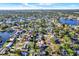 Expansive aerial view of a neighborhood with waterfront homes, lush greenery, and lake access at 9107 Bay Ne St, St Petersburg, FL 33702