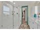 Bathroom with white tiled shower and white dual sink vanity at 9107 Bay Ne St, St Petersburg, FL 33702