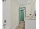 Bright bathroom featuring a shower, vanity, and painted door leading to closet for convenient and stylish storage at 9107 Bay Ne St, St Petersburg, FL 33702