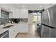 Bright kitchen features white cabinets, stainless steel appliances, and modern backsplash at 9107 Bay Ne St, St Petersburg, FL 33702