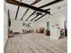 Spacious living room featuring hardwood floors, wood beams, a fireplace, and an open floor plan at 9107 Bay Ne St, St Petersburg, FL 33702
