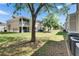 Lush backyard with mature trees and building exteriors, offering a serene outdoor space at 9516 Amberdale Ct # 202, Riverview, FL 33569