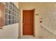 Front door in an apartment building featuring security features, a fire extinguisher, and a glass block window at 9516 Amberdale Ct # 202, Riverview, FL 33569
