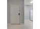 Apartment entryway with white door, tiled floors, and an adjacent white kitchen appliance at 9516 Amberdale Ct # 202, Riverview, FL 33569