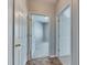 Hallway leading to carpeted room showcases white trim and wood-look flooring at 9516 Amberdale Ct # 202, Riverview, FL 33569