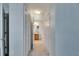 Hallway with multiple closets leads to a bathroom, offering ample storage space at 9516 Amberdale Ct # 202, Riverview, FL 33569