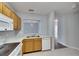 Functional kitchen features white appliances, light wood cabinetry, and stainless-steel sink at 9516 Amberdale Ct # 202, Riverview, FL 33569