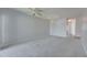 Open living room features neutral walls and carpet with a ceiling fan and pendant lighting at 9516 Amberdale Ct # 202, Riverview, FL 33569