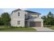 Two-story home with gray siding, a two-car garage, and a well-maintained front lawn at 10225 Purple Leaf Ct, Riverview, FL 33578