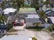Backyard featuring an open-air structure, driveway, and mature landscaping at 107 13Th Ave, St Pete Beach, FL 33706