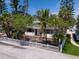 Quaint home with a white picket fence, tropical landscaping, and a welcoming entrance at 107 13Th Ave, St Pete Beach, FL 33706