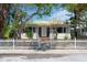 Charming home featuring a classic white picket fence and inviting front yard with mature landscaping at 107 13Th Ave, St Pete Beach, FL 33706