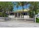 Charming home with a white picket fence and lush landscaping, offering great curb appeal at 107 13Th Ave, St Pete Beach, FL 33706