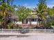 Inviting home with a white picket fence and mature landscaping at 107 13Th Ave, St Pete Beach, FL 33706