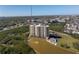 Beautiful condominium building with multiple balconies, surrounded by lush landscaping and a scenic lake at 10851 Mangrove Cay Ne Ln # 714, St Petersburg, FL 33716