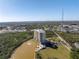 Luxury condominium building with beautiful architecture, overlooking a serene lake and lush green surroundings at 10851 Mangrove Cay Ne Ln # 714, St Petersburg, FL 33716