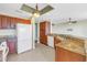 Spacious kitchen with granite countertops, a large refrigerator, and a functional layout for easy meal preparation at 10851 Mangrove Cay Ne Ln # 714, St Petersburg, FL 33716