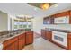 Open kitchen with granite countertops, stainless steel appliances, and a breakfast bar overlooking the dining area at 10851 Mangrove Cay Ne Ln # 714, St Petersburg, FL 33716