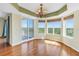 Living room featuring hardwood floors, tray ceilings, access to the balcony and many windows at 10851 Mangrove Cay Ne Ln # 714, St Petersburg, FL 33716