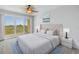 Cozy main bedroom with a tufted headboard, balcony access, and serene views, perfect for relaxation at 10851 Mangrove Cay Ne Ln # 714, St Petersburg, FL 33716