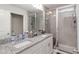 Bathroom featuring dual sinks, granite countertops, and a glass-enclosed shower with tiled walls at 10924 Brightleaf Ct, Riverview, FL 33569