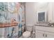 Stylish bathroom with nautical-themed shower curtain and granite countertop at 10924 Brightleaf Ct, Riverview, FL 33569