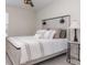 Comfortable bedroom with a decorative headboard and stylish bedside table with a table lamp at 10924 Brightleaf Ct, Riverview, FL 33569