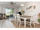 Dining room with a large table, six chairs, and sliding glass doors to the patio at 10924 Brightleaf Ct, Riverview, FL 33569