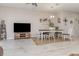 Dining area with modern table and chairs, a stylish chandelier, and an adjacent tv at 10924 Brightleaf Ct, Riverview, FL 33569