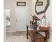 Elegant foyer features stylish table décor, a decorative mirror, and natural light at 10924 Brightleaf Ct, Riverview, FL 33569