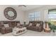 Comfortable living room with leather seating, a large mirror, and a cozy atmosphere at 10924 Brightleaf Ct, Riverview, FL 33569