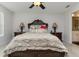 Luxurious main bedroom featuring a detailed wood headboard and matching dark wood bedside tables at 10924 Brightleaf Ct, Riverview, FL 33569