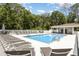 Community pool area with lounge chairs, umbrellas, and covered seating space at 10924 Brightleaf Ct, Riverview, FL 33569