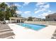 Community pool with lounge chairs and covered pavilion for relaxing by the water at 10924 Brightleaf Ct, Riverview, FL 33569