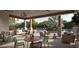 Inviting outdoor patio featuring comfortable seating, a dining area, and lush landscaping at 11135 E 65Th Ter, Palmetto, FL 34221