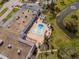 Community pool featuring lounge chairs, landscaping, and a nearby lake at 11225 Godwit Ct, New Port Richey, FL 34654