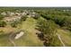 Scenic aerial of golf course with lush green fairways, mature trees, serene ponds, and manicured sand traps at 11225 Godwit Ct, New Port Richey, FL 34654