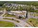 Aerial view showcasing community amenities, including a clubhouse, pool, bocce ball court, and ample parking at 11225 Godwit Ct, New Port Richey, FL 34654
