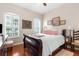 Well-appointed bedroom with plantation shutters, a classic bed frame, and hardwood floors, offering a cozy retreat at 11225 Godwit Ct, New Port Richey, FL 34654