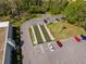 Aerial view of bocce ball courts, parking and benches near community clubhouse at 11225 Godwit Ct, New Port Richey, FL 34654