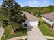 Charming home featuring a well-manicured lawn, mature trees, and an attached two-car garage at 11225 Godwit Ct, New Port Richey, FL 34654