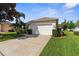 Well-maintained home with a two-car garage and manicured lawn in a residential neighborhood at 11225 Godwit Ct, New Port Richey, FL 34654