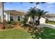 Charming home with lush landscaping, healthy green lawn, and decorative potted plants at 11225 Godwit Ct, New Port Richey, FL 34654
