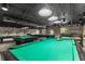 Spacious game room with multiple pool tables and ample lighting at 11225 Godwit Ct, New Port Richey, FL 34654