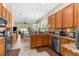 Open concept kitchen and dining area with stainless steel appliances, tiled floors, and lots of natural light at 11225 Godwit Ct, New Port Richey, FL 34654